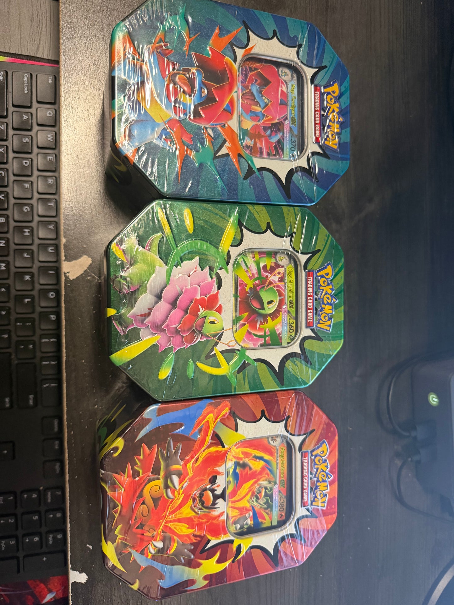 Pokémon TCG Mega Evolution Ascended Heroes tins featuring Mega Feraligatr ex, Mega Meganium ex, and Mega Emboar ex